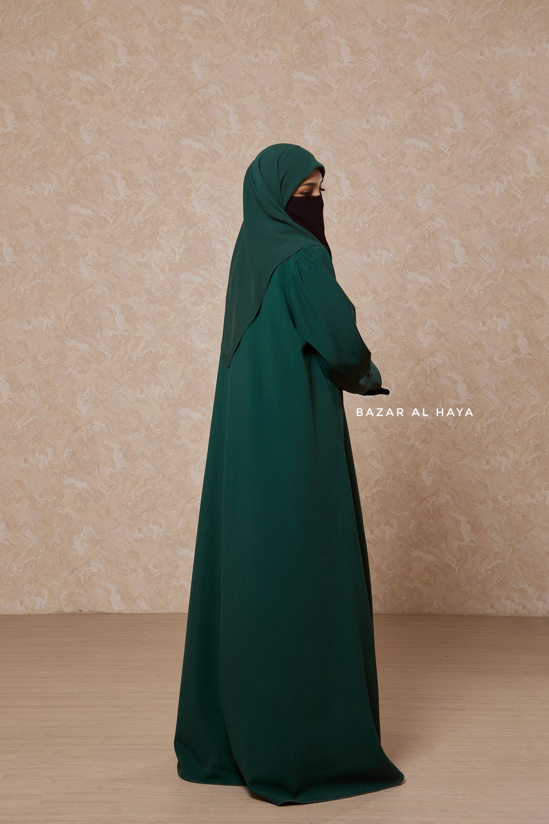 emerald green abaya dress EMERALD ABAYA Emerald green embellished Abaya set with flounced sleeves. Comes with a dress and headscarf. Abayas from Almahra Atelier at Boksha
